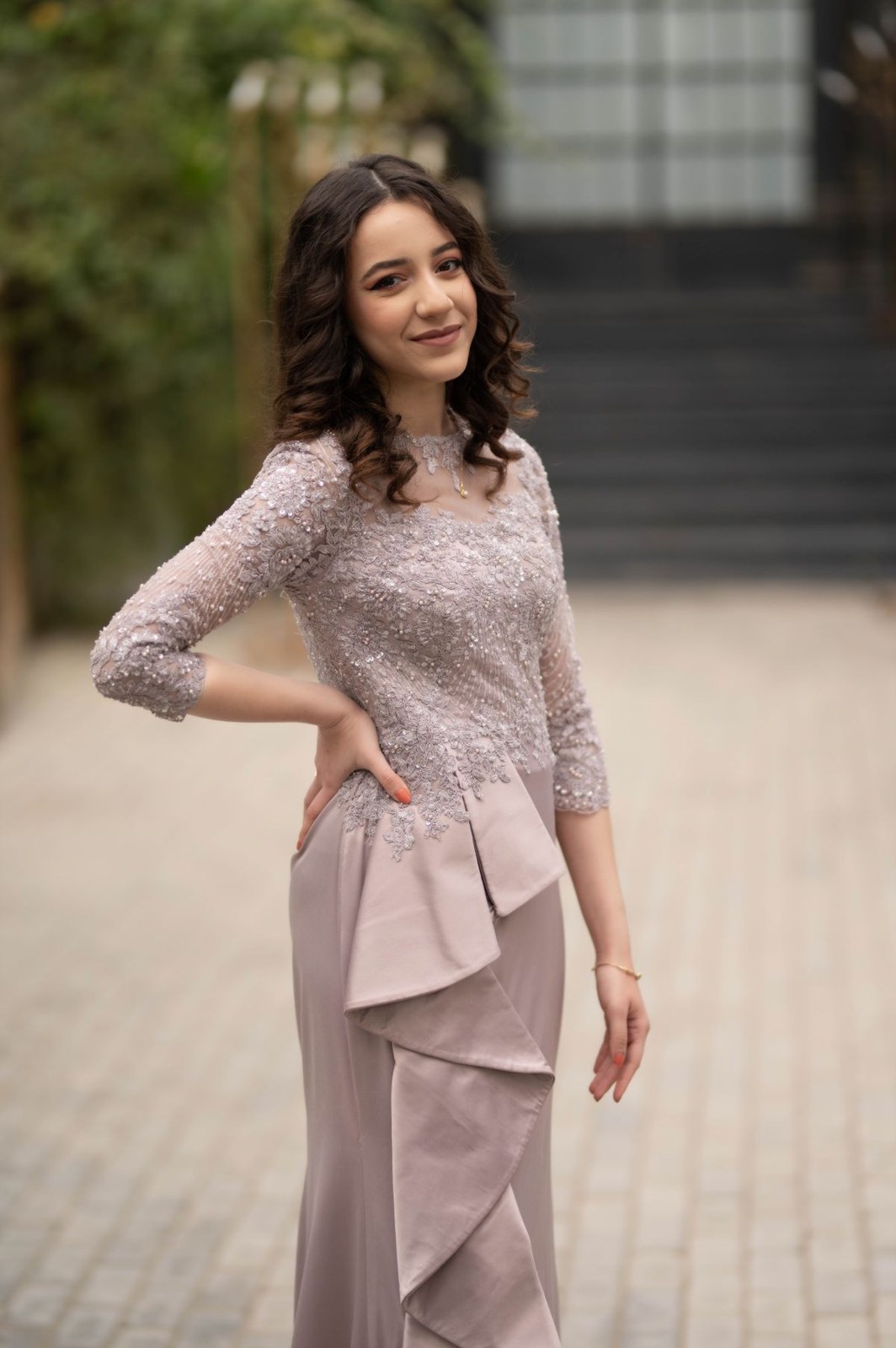 Dusty-pink lace long-sleeve top and matching long skirt with draped waist detail.