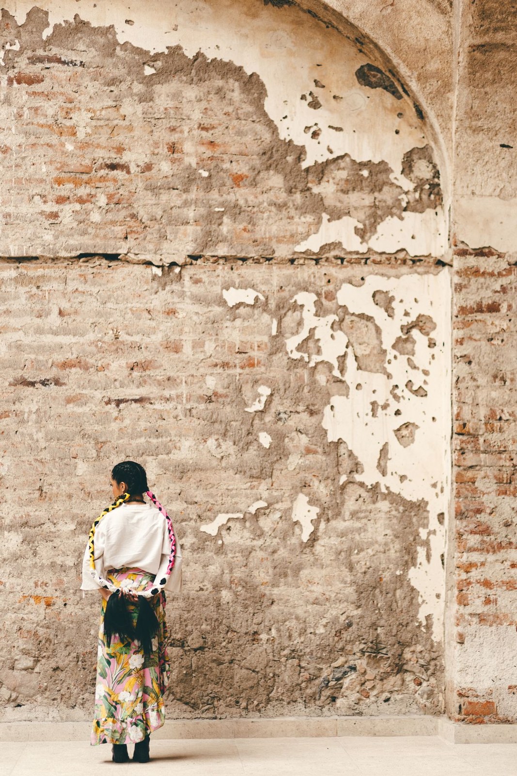 White long-sleeve top and black floral maxi skirt in a full-length side view.